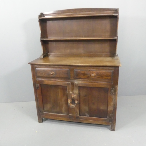 2656 - An early 20th century two-section oak dresser. Width 107cm, height 143cm, depth 44cm.