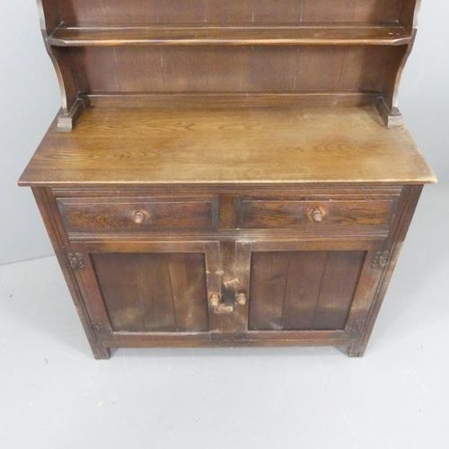 2656 - An early 20th century two-section oak dresser. Width 107cm, height 143cm, depth 44cm.