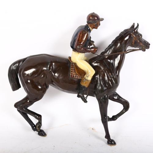 128 - A painted spelter model of a jockey and racehorse, H25cm (lacking base)