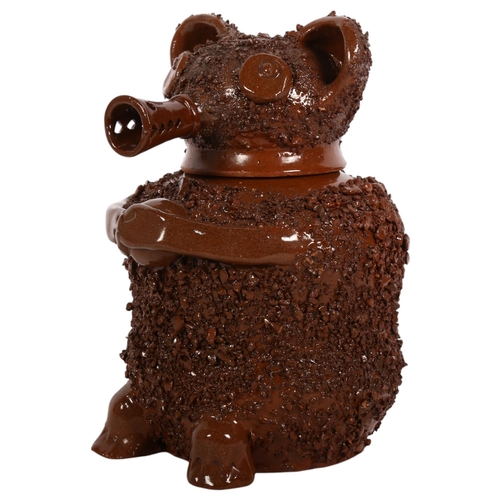 142 - A Staffordshire style glazed terracotta brown bear jar with impressed mark to base, height 23cm.