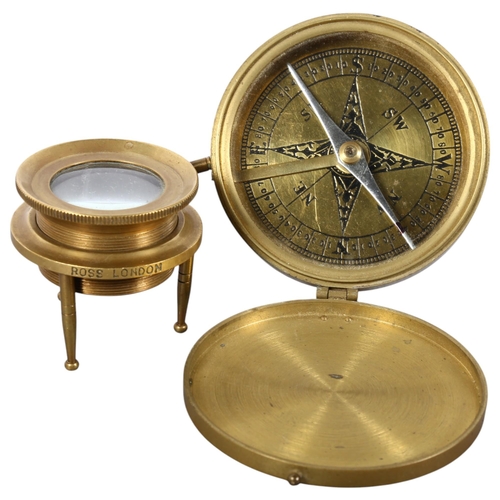 159 - Stanley London, a brass-cased compass, and a brass map reading lens on stand by Ross of London