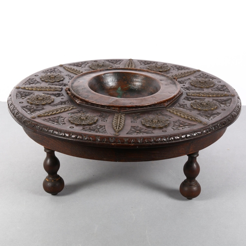 174 - A Spanish carved wood circular brazier, with copper bowl, and applied brass decoration, diameter 43c... 