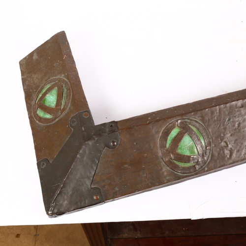 19 - An Art Nouveau hammered copper fire surround, with stylised green enamel disc decoration, L107cm, D3... 