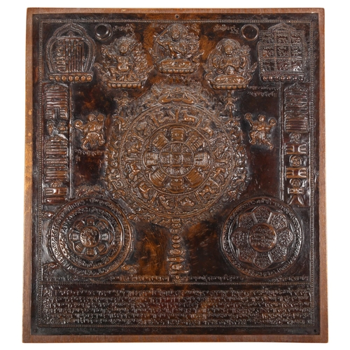 195 - A 19th century Tibetan Thangka, a repousse decorated copper panel depicting Buddhas with script, pan... 