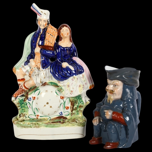 200 - A Victorian Staffordshire clock group surmounted by a Scottish couple, and an Antique Toby jug, Staf... 