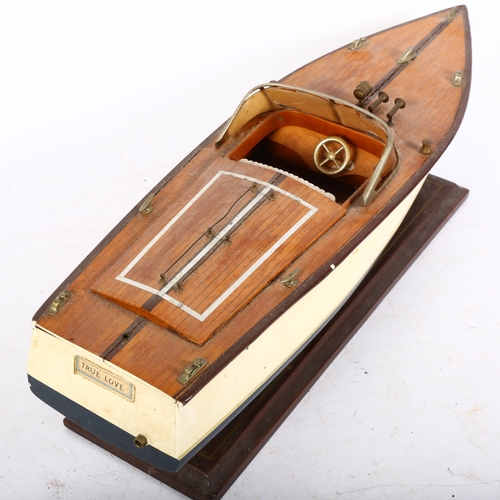 221 - A small painted scratch-built study of a motor launch on stand, (True Love), boat length 50cm