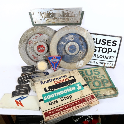 223 - A collection of bus related memorabilia, including bus stop signs, 2 Leyland wheel hubs, coach plaqu... 