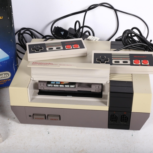 273 - A Nintendo Entertainment System (NES), with associated power cable, controllers and gun, together wi... 