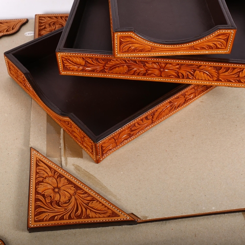 275 - A graduated set of 3 tan tooled leather desk trays, longest 38cm, together with 4 tan tooled leather... 