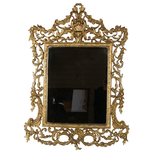 303 - An ornate gilt-metal framed wall mirror, overall 91cm x 63cm