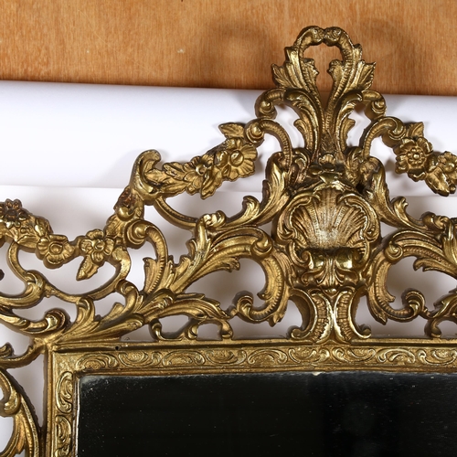 303 - An ornate gilt-metal framed wall mirror, overall 91cm x 63cm