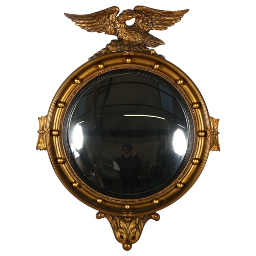 306 - A giltwood and plaster convex wall mirror with Federal style eagle mount, overall 69cm x 53cm