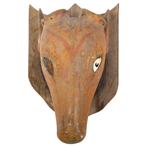 32 - A Folk Art carved and painted wood cow's head on oak shield plaque, overall length 48cm, head length... 