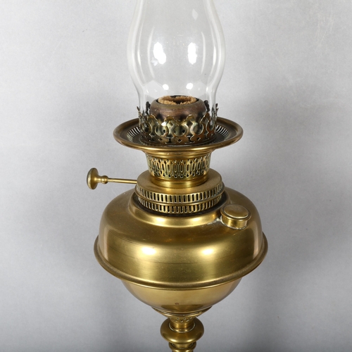 323 - An ornate Antique brass oil lamp, overall height 77cm