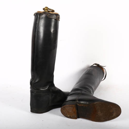 346 - A pair of lady's black leather riding boots, with wooden trees and brass ring handles