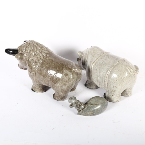 347 - A glazed pottery bison, H21cm, a similar rhinoceros and a carved soapstone hippo