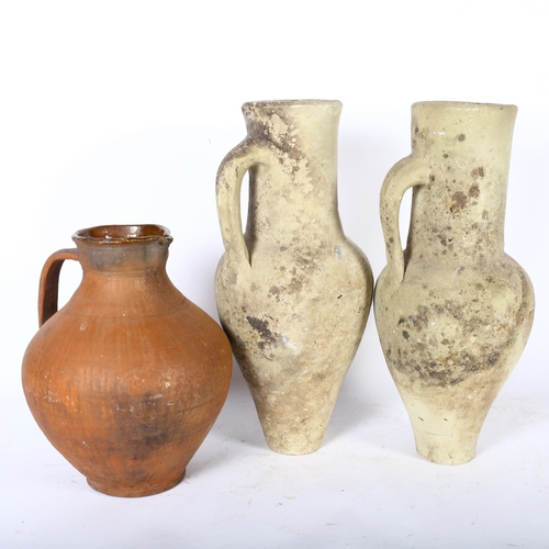 361 - A pair of single-handled pottery ewers, and a terracotta jug