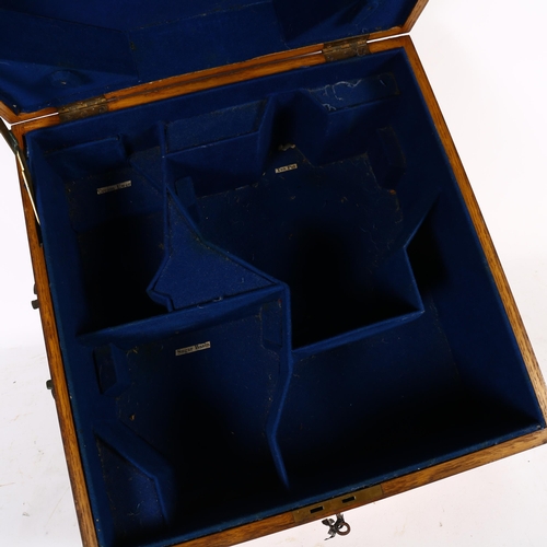 397 - An oak 2-handled box with fitted interior for a silver tea set, with armorial brass plaque to the li... 