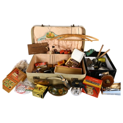 399 - A suitcase and a box of collectables, including decorative tins, coat hangers, clock, tape, etc