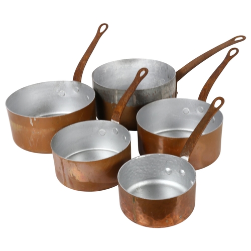 419 - A graduated set of 4 copper saucepans with steel handles, largest 18.5cm, and another similar saucep... 