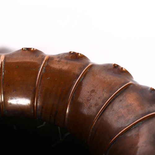 445 - A large Antique lobed copper jardiniere with shaped rim, 45cm across, on wrought-iron stand