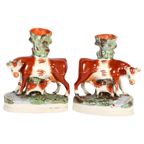 469 - A pair of Victorian Staffordshire cow and calf figure vases, H28cm