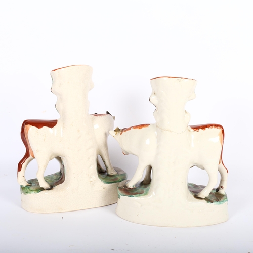 469 - A pair of Victorian Staffordshire cow and calf figure vases, H28cm