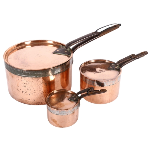 476 - Early 19th century graduated set of 3 copper saucepans with iron handles, and matching lids, all ins... 