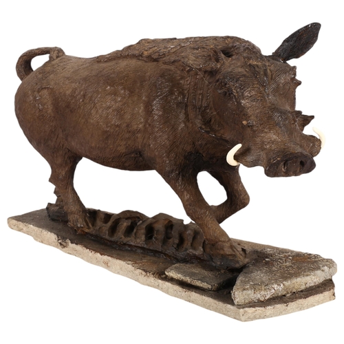 484 - A carved wood sculpture of a wild boar, mounted on stone plinth, H33cm