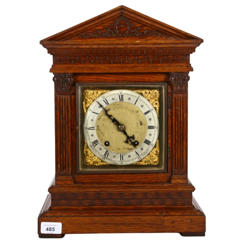 485 - Antique carved oak-cased mantel clock, with brass dial having applied cherubs, with 2-train movement... 