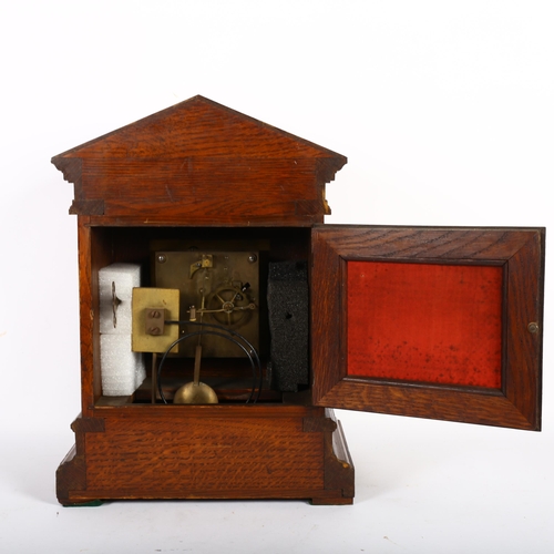 485 - Antique carved oak-cased mantel clock, with brass dial having applied cherubs, with 2-train movement... 