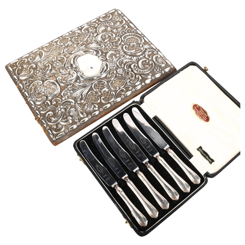 558 - An ornate applied silver decorated blotter cover (cover only), and a cased set of sterling silver-ha... 