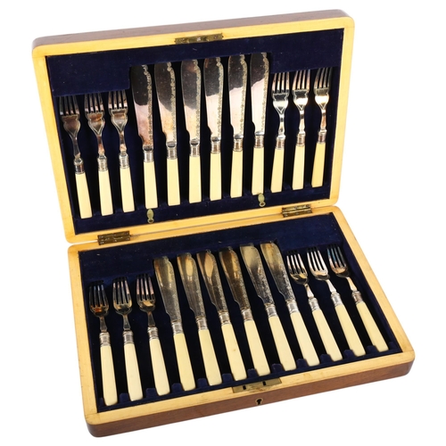 560 - An early 20th century canteen of fish cutlery for 6 people, with engraved blades and ivorine handles... 