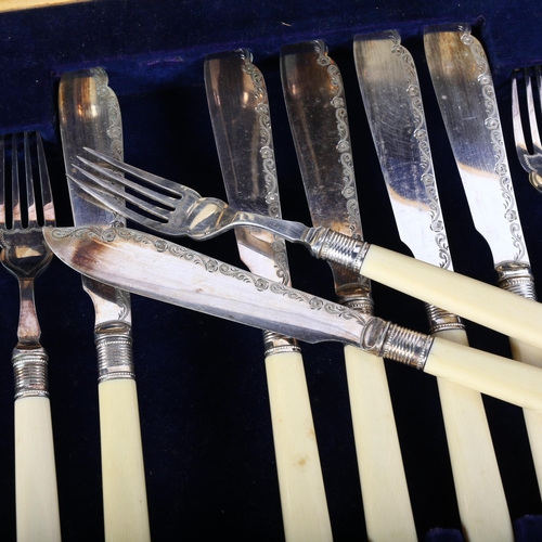 560 - An early 20th century canteen of fish cutlery for 6 people, with engraved blades and ivorine handles... 