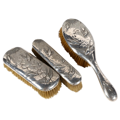 561 - 3 silver-backed brushes with swallow and swift embossed decoration