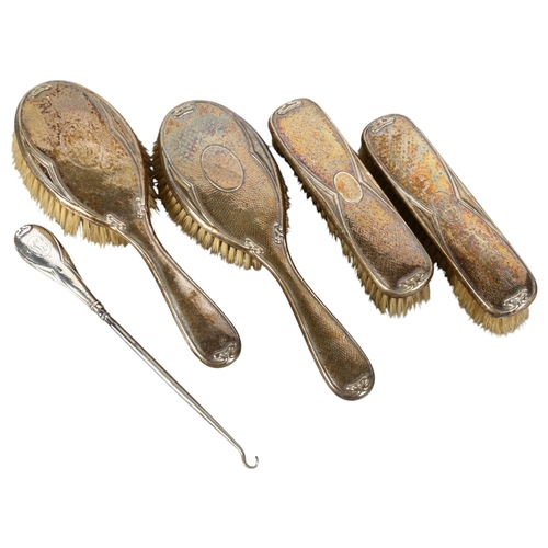 563 - An Art Nouveau silver-backed 5-piece brush and button hook set