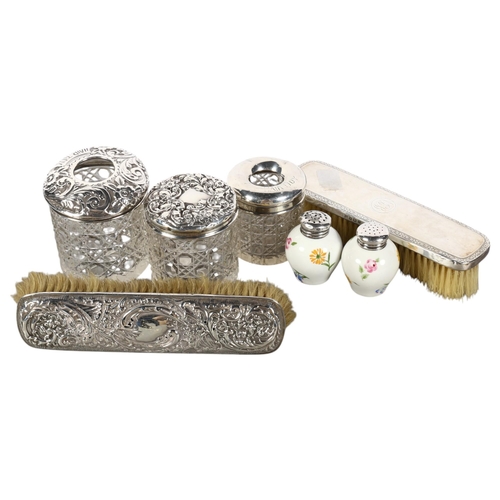 565 - 2 silver-backed dressing table brushes, 2 glass-top hair tidies, a silver-topped toilet jar, and a p... 