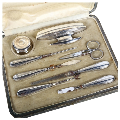 566 - An Art Deco 8-piece vanity set in fitted case