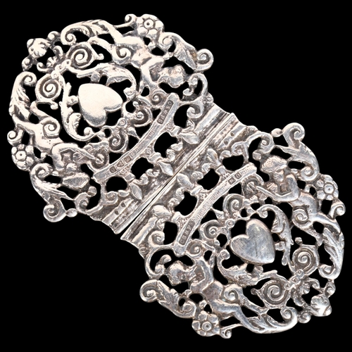 590 - A late Victorian silver nurse's buckle, Saunders & Shepherd, Chester 1897, pierced heart and cherub ... 