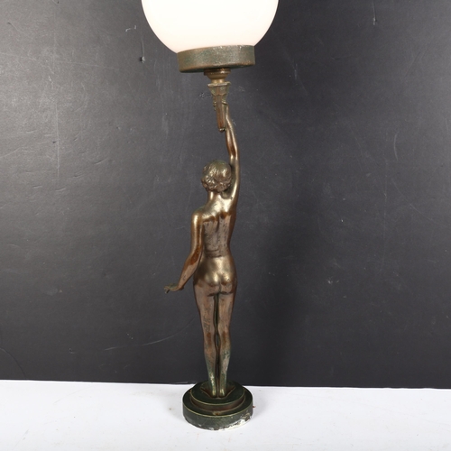 7 - An Art Deco bronze table lamp in the form of a naked lady, with pink glass shade, on circular steppe... 