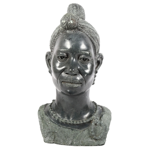 8 - A large green stone bust of an African woman, unsigned, height 45cm.