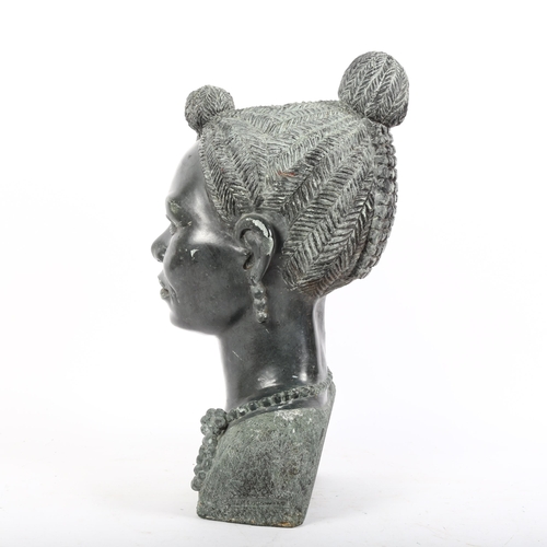 8 - A large green stone bust of an African woman, unsigned, height 45cm.