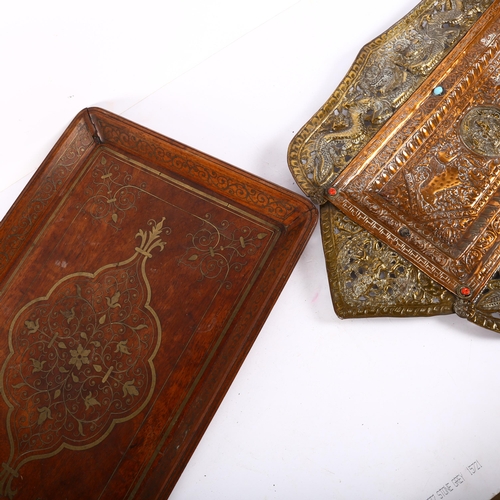 646 - An Eastern hardwood tea tray with inlaid brass decoration, 52.5cm, and an ornate pressed copper pane... 