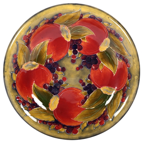 692 - A Moorcroft Pomegranate design dish with pale green ground background, signed with maker's stamp to ... 