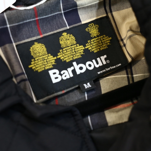 742 - BARBOUR - a tartan long quilted blue jacket, size medium