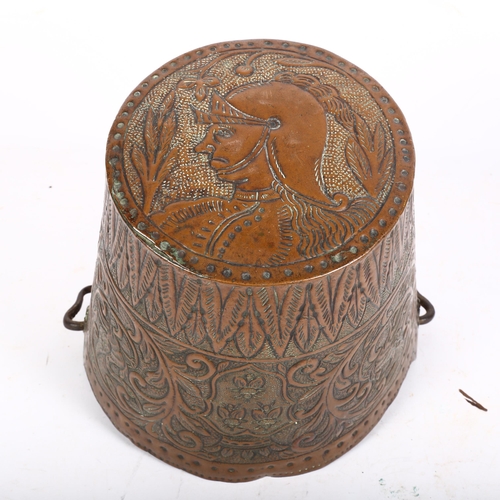 751 - An ornate Antique copper bucket with detailed allover repousse hammered decoration, including to bas... 