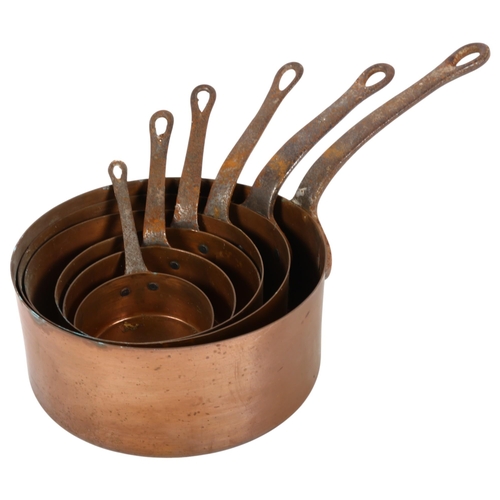 778 - A graduated set of copper saucepans with steel handles, largest 18.5cm