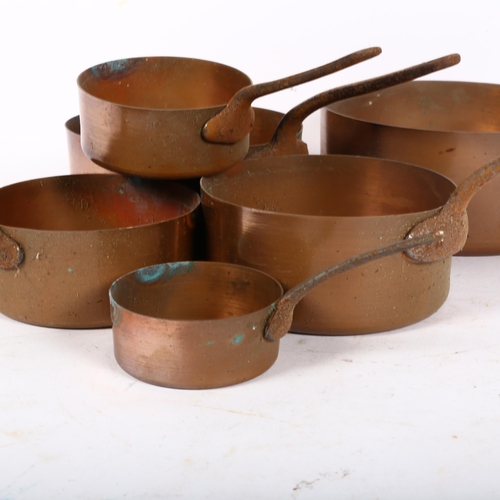 778 - A graduated set of copper saucepans with steel handles, largest 18.5cm