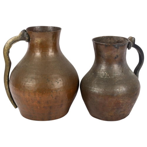 795 - 2 similar copper hand hammered Middle Eastern style water jugs, largest height 26cm (2)