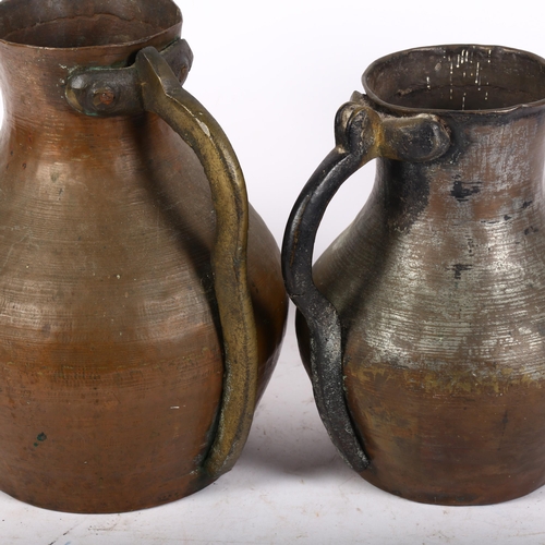 795 - 2 similar copper hand hammered Middle Eastern style water jugs, largest height 26cm (2)